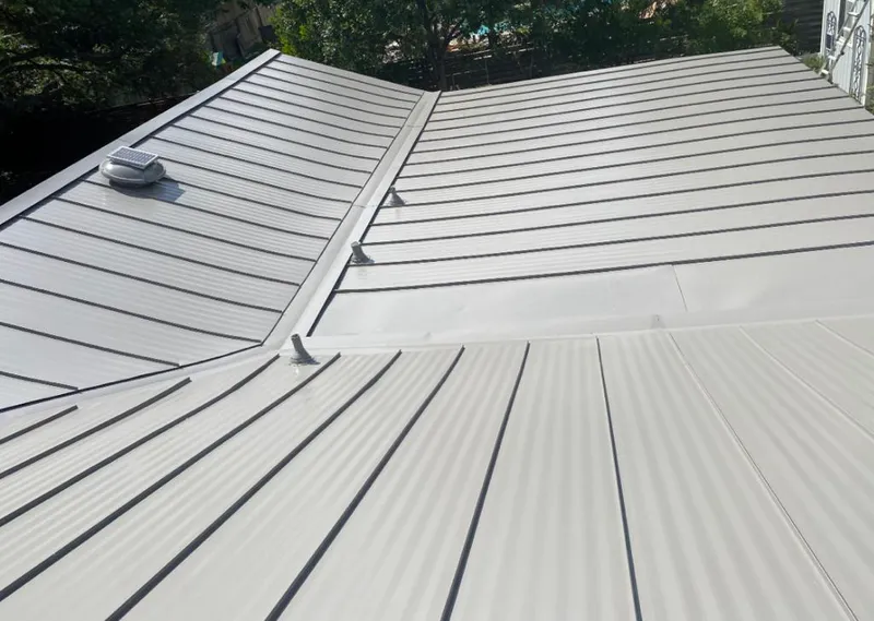 Solar attic fan installed on a metal roof for Roof Ventilation in Versailles